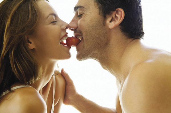 Couple eating a strawberry