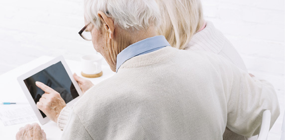 Two senior adults with iPads