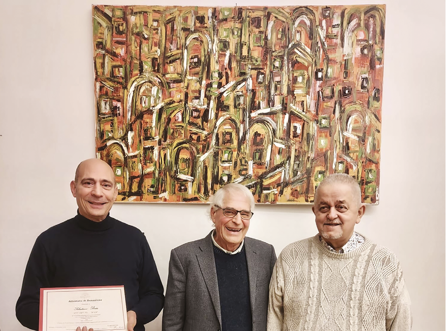 Immagine del quadro donato e, da sinistra, Sebastiano Resta, Elio De Leo, Presidente dell’Istituto dei ciechi Francesco Cavazza e Marco Trombini, membro del Consiglio di Amministrazione dell’Istituto nominato dall’Unione Italiana Ciechi ed Ipovedenti