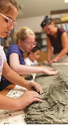 A woman molding clay 