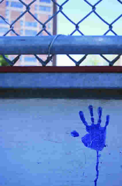 Blue imprint of a hand on a wall