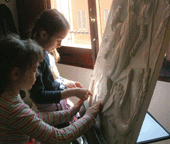 Picture of two little girls touching a work of art in bas relief