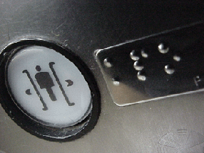 Picture of a button with Braille inscription