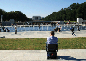 Picture of a person in a wheelchair in a European square